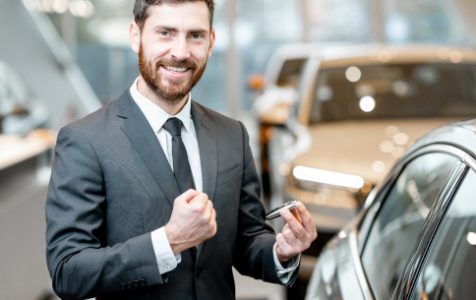 businessman-with-keys-in-the-car-showroom-2021-12-09-01-55-38-utc-1.jpg